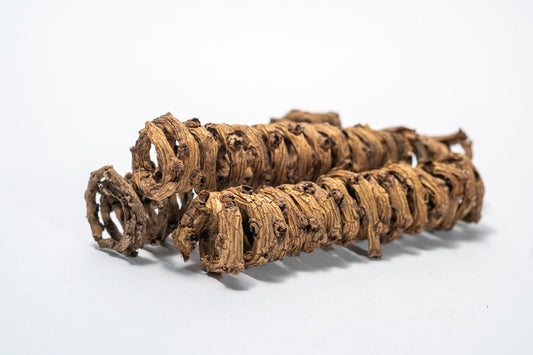 Close up of Three Palm Tail Springs dry, twisted Borassus flabellifer roots with knobby, segmented shapes and a brown hue—perfect as unique aquarium decor. Presented coiled and isolated on a white background.