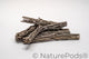 Stack of many six inch pieces of cholla wood with holes on a white background.  Cholla wood is used as isopod food, hermit crab enrichment, and aquarium wood.