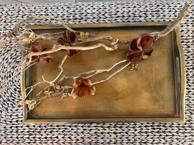 Decorative tray with floral design on a textured surface