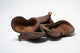 A photo of a pile of Jungle Pods. They are brown textured shells on a white background.
