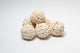 A photo of a pile of Sola Atta Balls. They are white textured round balls on a white background.