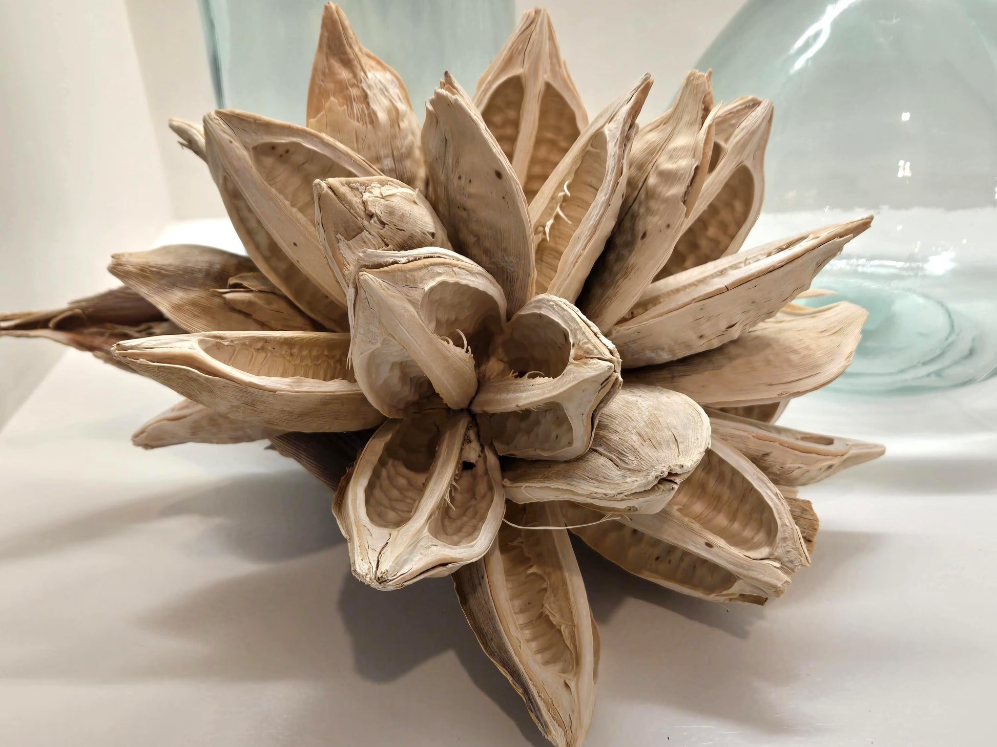 Wooden flower sculpture on a white surface