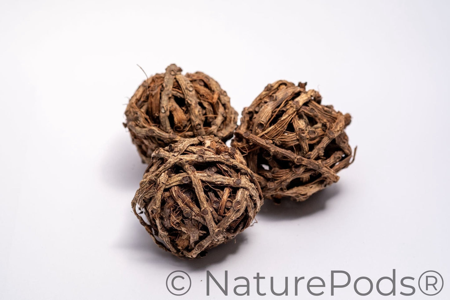 Three brown vine balls on a white background.  Used for harvesting springtails and as home decor in a bowl.