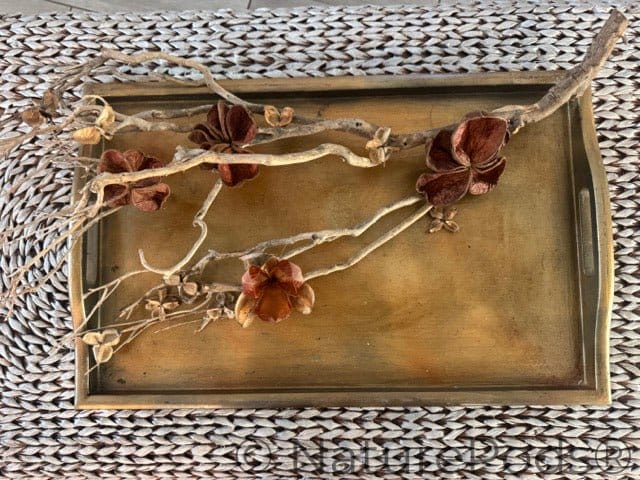 Decorative tray with floral design on a textured surface